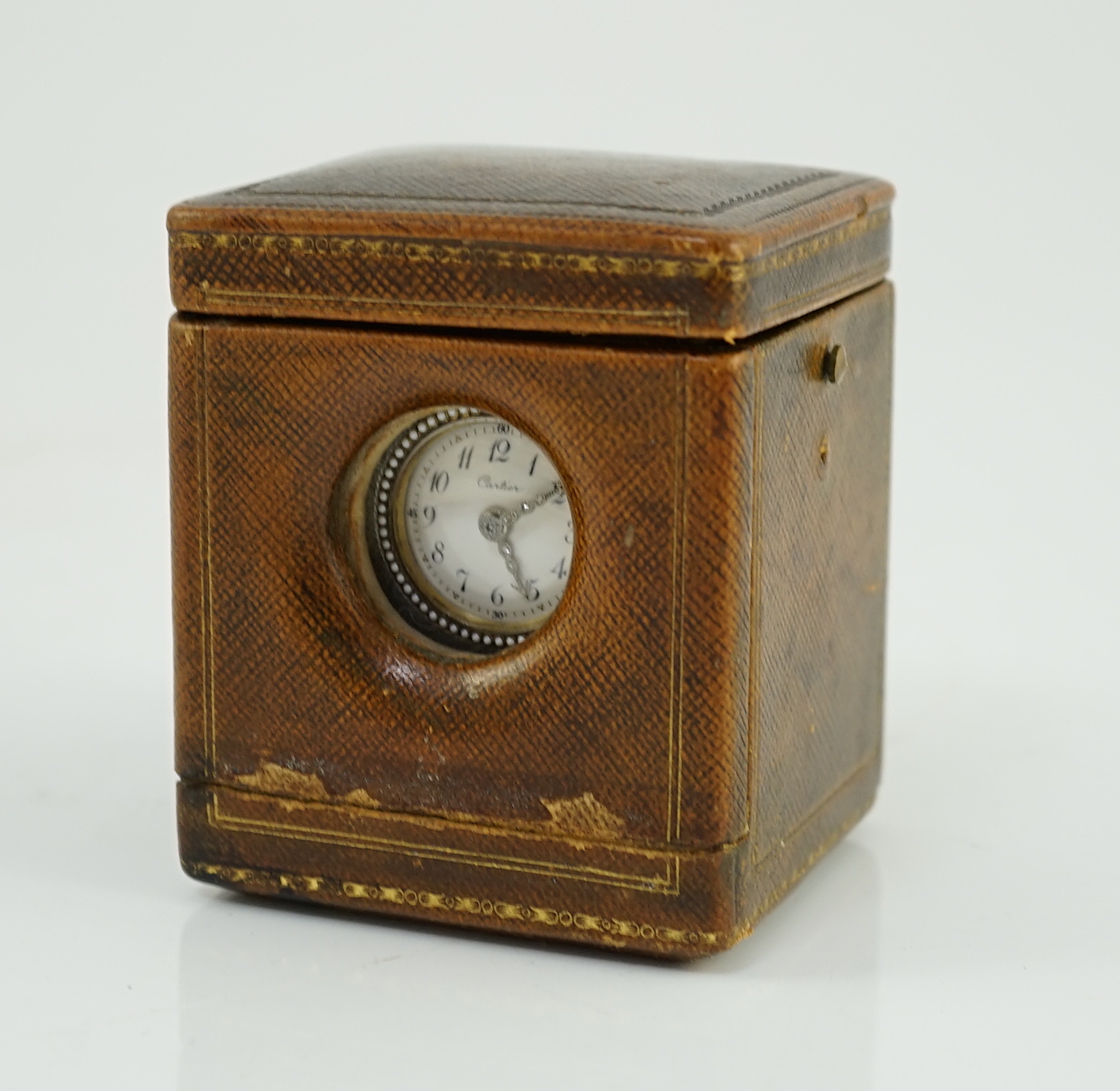 A fine Belle Époque Cartier silver, gold, diamond and guilloche enamel mounted 'Mignonette' timepiece, on an agate plinth base